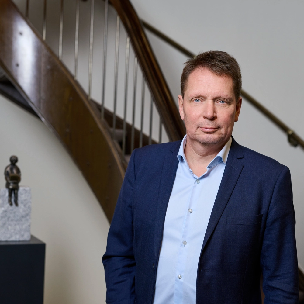 Henning Mortensen in front of old traditional staircase